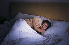 Girl Sleeping On The Bed With A Teddy Bear