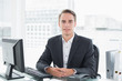 © lightwavemedia - Businessman in front of computer at office desk