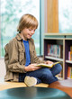© Tyler Olson - Happy Boy Reading Book In Library