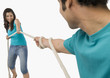 © imagedb.com - Young couple playing tug of war