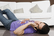 © imagedb.com - Man lying on the floor and talking on a mobile phone