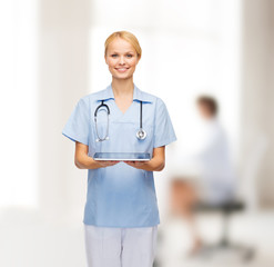 Poster - smiling female doctor or nurse with tablet pc