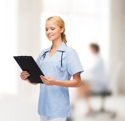 Poster - smiling female doctor or nurse with clipboard