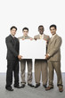 © imagedb.com - Portrait of four businessmen showing a blank placard
