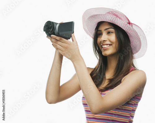 Fotografie, Obraz Close-up of a woman filming with a home video camera