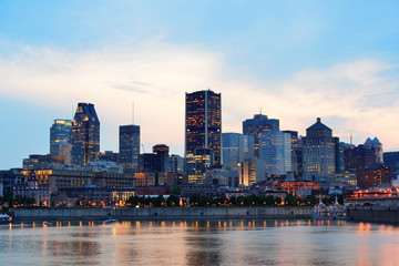 Wall Mural - Montreal over river at sunset