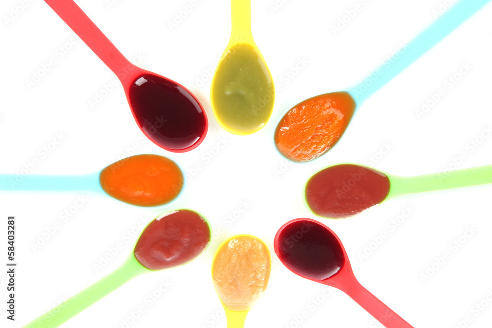 Baby puree in spoons isolated on white