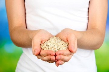 Wall Mural - Wheat grain in female hands on natural background