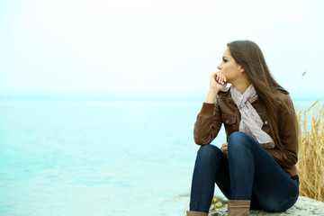 Wall Mural - Portrait of young serious woman near river