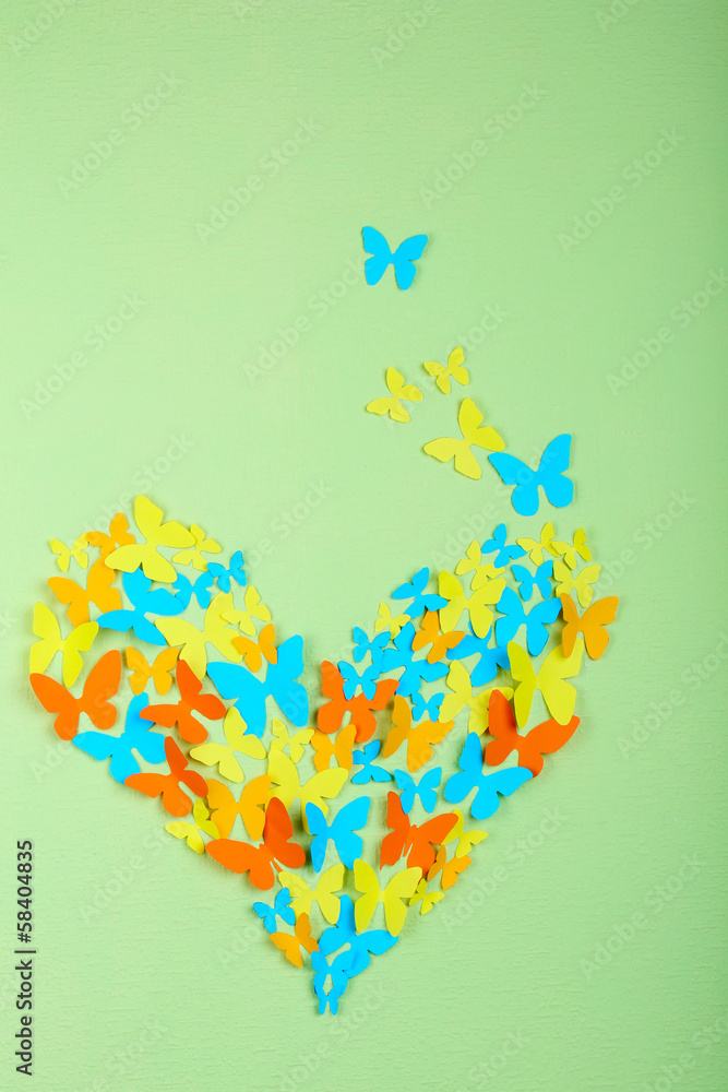 Paper butterflies on green wall