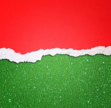 Red Torn Paper Over Green Glitter Background