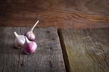 Wall Mural - Background with old boards and garlic.