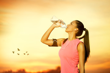 Female jogger drinking water