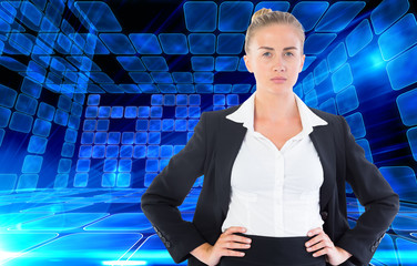 Wall Mural - Composite image of businesswoman standing with hands on hips