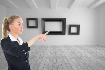 Wall Mural - Composite image of businesswoman pointing somewhere