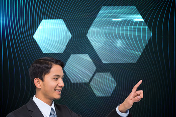 Poster - Composite image of smiling asian businessman pointing