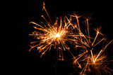 Fototapeta Sypialnia - Christmas sparkler on black background. Bengal fire