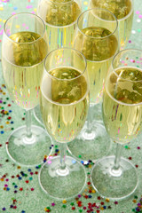 Wall Mural - Glasses with champagne on shiny background