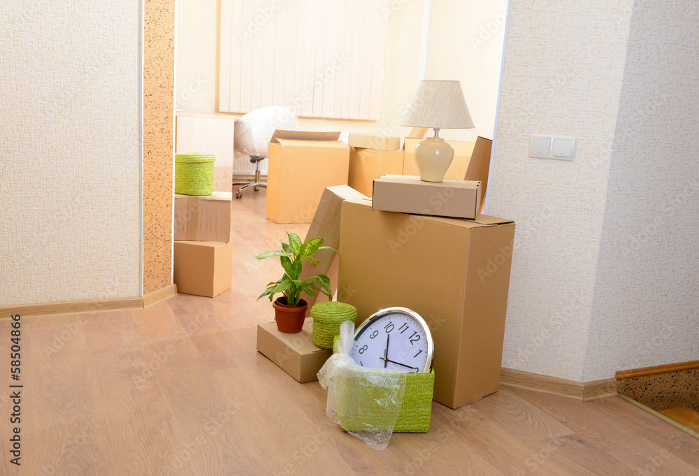 Empty room with stack of cartons: moving house concept