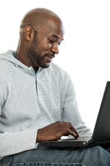 Wall Mural - Handsome black man on laptop computer