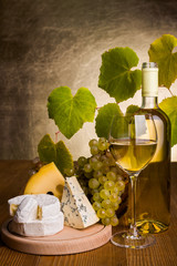 Wall Mural - White wine with grape and cheese snack