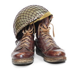 Retro military helmet and boots on a white background.