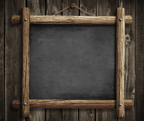 Wall Mural - Grunge blackboard hanging on wooden wall as a background