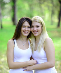 close up portrait of two happy women looking at camera and smili