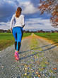 Sporty female walking and running on a road
