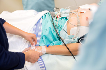 Canvas Print - Nurse Attaching IV Solution On Patient's Hand