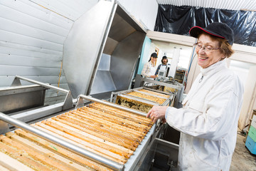 Happy Beekeeper Working On Honey Extraction Machine