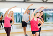 © Syda Productions - group of smiling people stretching in the gym