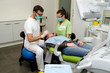 © starsstudio - Dentist, assistant and patient in dental clinic