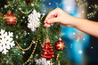 Decorating Christmas tree on bright background