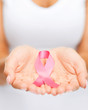© Syda Productions - hands holding pink breast cancer awareness ribbon