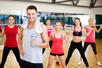 Canvas Print - smiling trainer in front of group of people