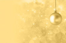 Yellow Christmas Bauble On Starry Bokeh Background