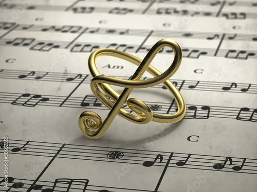 Fotografía musical note ring with score in background