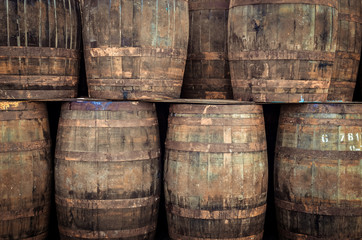 Stacked old whisky barrels