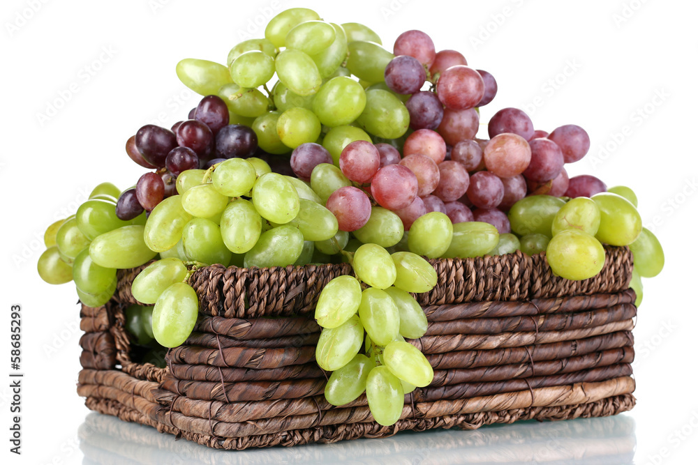 Ripe green and purple grapes in basket isolated on white