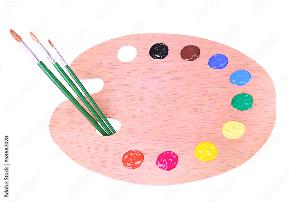 Wooden art palette with paint and brushes isolated on white