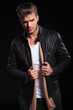 © Viorel Sima - serious fashion man pulling his leather jacket