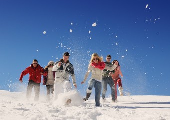 friends have fun at winter on fresh snow