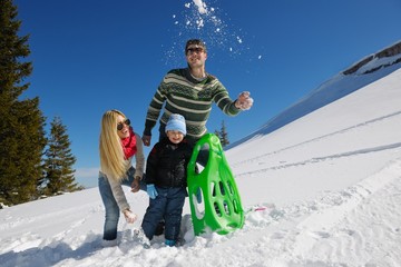 Wall Mural - family having fun on fresh snow at winter vacation