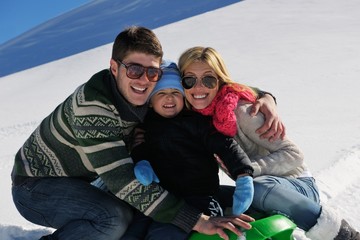 Wall Mural - family having fun on fresh snow at winter vacation