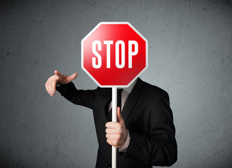 Businessman holding a stop sign