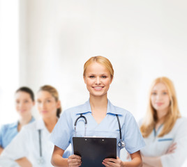 Poster - smiling female doctor or nurse with clipboard