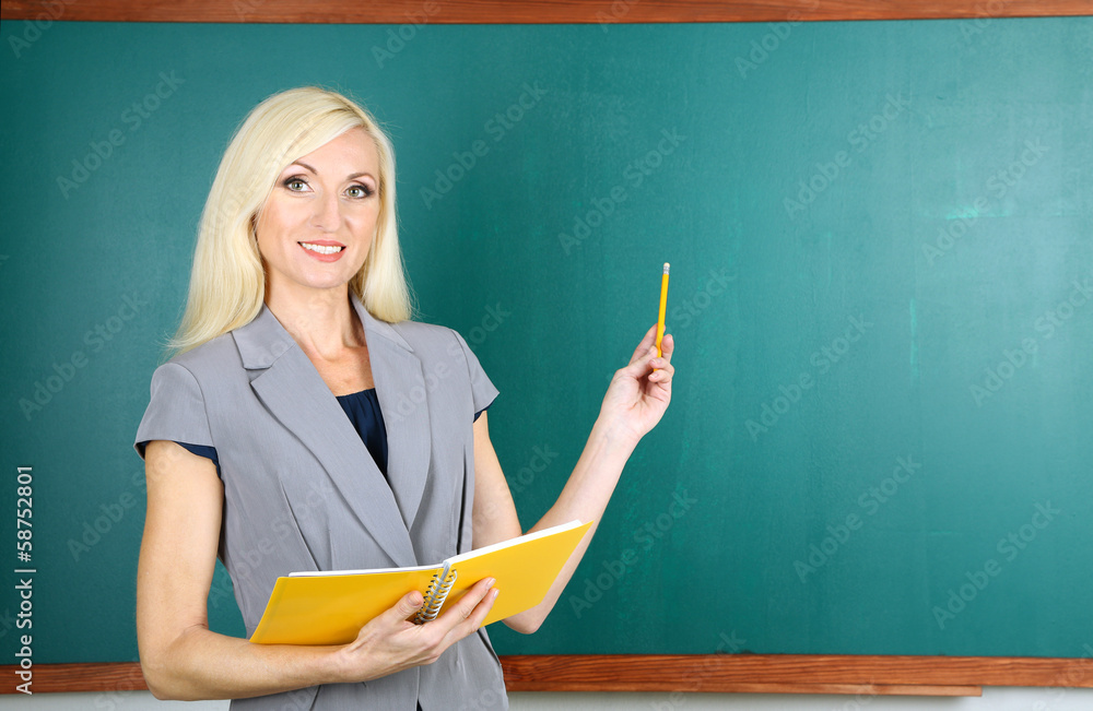 School teacher near blackboard close-up