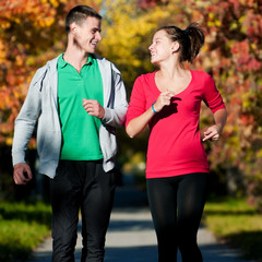 Wall Mural - Young man and woman running