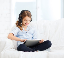 Poster - girl with tablet pc and headphones at home